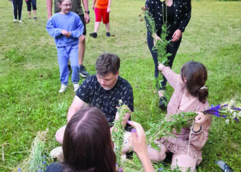 Jaunimas, tradiciškai prisirinkęs žolynėlių, kurie šią sausą vasarą negausiai sužaliavo, pynė Joninių vainikus. Tai neatsiejama Joninių vakaro dalis.